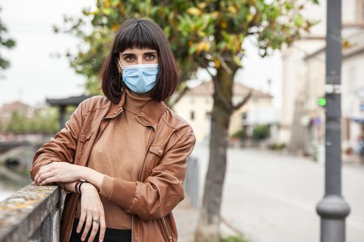 Portrait of a Girl with medical mask outdoor during covid quarantine in Italy