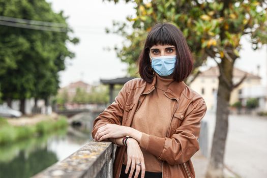 Portrait of a Girl with medical mask outdoor during covid quarantine in Italy