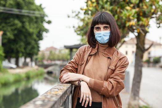 Portrait of a Girl with medical mask outdoor during covid quarantine in Italy