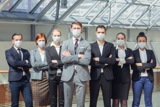 Business people wearing surgical masks and standing together, healthcare and covid-19 prevention concept