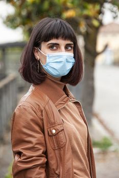 Portrait of a Girl with medical mask outdoor during covid quarantine in Italy