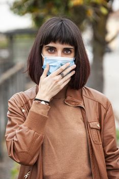 Portrait of a Girl with medical mask outdoor during covid quarantine in Italy