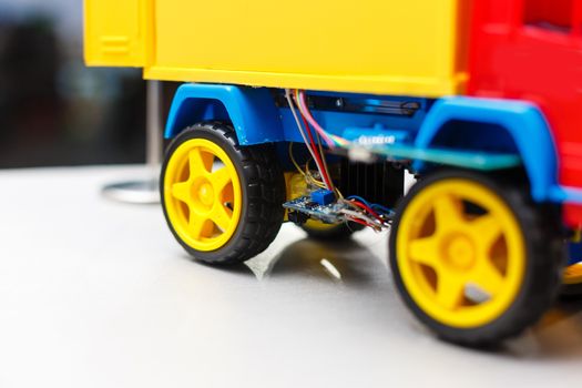 A blue yellow and red toy car. High quality photo