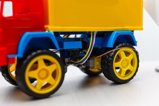 A blue yellow and red toy car. High quality photo