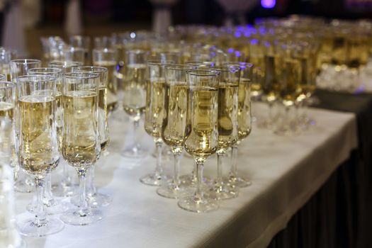 A row of wine glasses sitting on a table. High quality photo