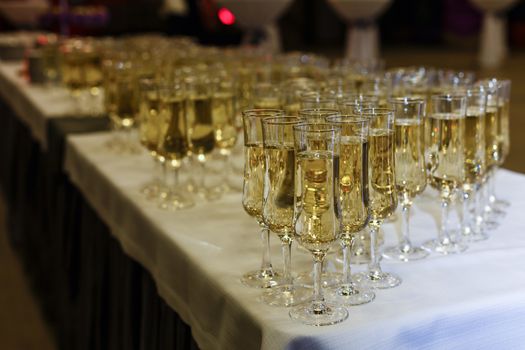A row of wine glasses sitting on a table. High quality photo