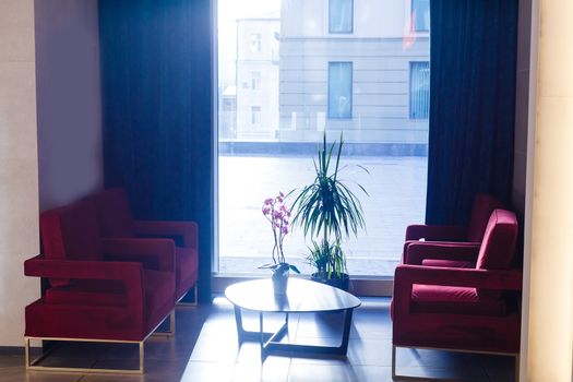 A large red chair in a room. High quality photo