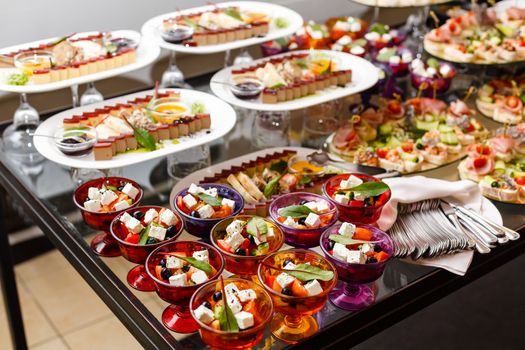 A group of people sitting at a table with a plate of food. High quality photo