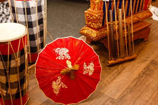 A close up of a colorful umbrella sitting on top of a wooden table. High quality photo