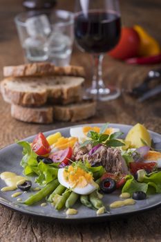 salad nicoise on a wooden background
