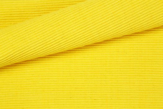 Detail of yellow woven cotton place mat - background, full frame