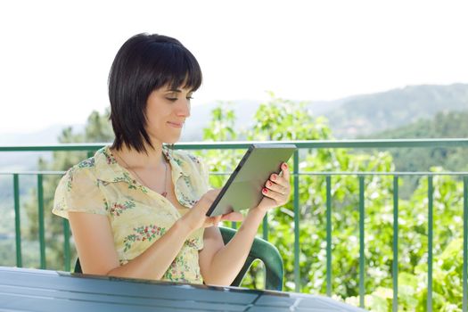 casual woman working with a tablet pc, outdoor