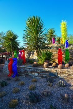 USA, PHENIX, ARIZONA- NOVEMBER 17, 2019: multi-colored plastic animal figures among cacti of different species in the botanical garden of the Phoenix, Arizona