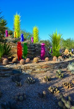 USA, PHENIX, ARIZONA- NOVEMBER 17, 2019: multi-colored plastic animal figures among cacti of different species in the botanical garden of the Phoenix, Arizona