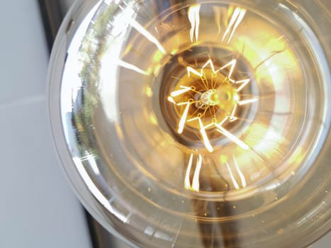 Electricity current inside a retro crystal clear light bulb.