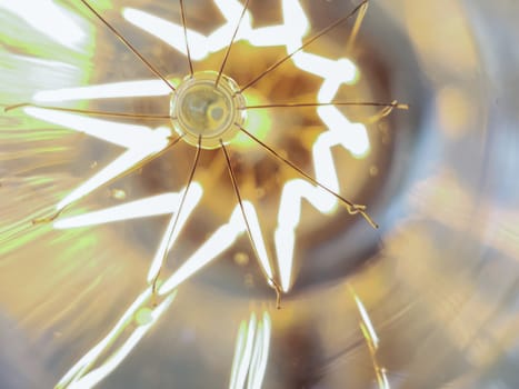 Electricity current inside a retro crystal clear light bulb.