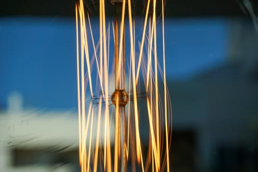 Electricity current inside a retro crystal clear light bulb.