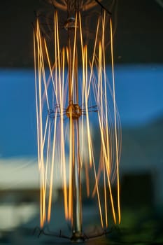 Electricity current inside a retro crystal clear light bulb.