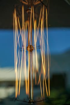 Electricity current inside a retro crystal clear light bulb.