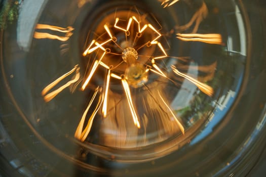 Electricity current inside a retro crystal clear light bulb.