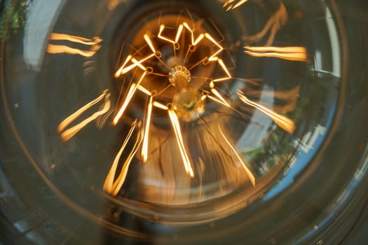 Electricity current inside a retro crystal clear light bulb.