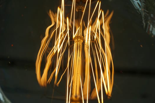 Electricity current inside a retro crystal clear light bulb.