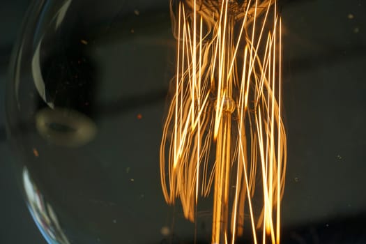 Electricity current inside a retro crystal clear light bulb.