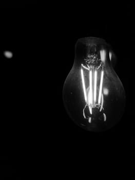 Amazing spiral electric current inside a retro crystal clear light bulb.