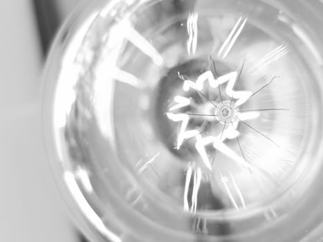 Amazing spiral electric current inside a retro crystal clear light bulb.