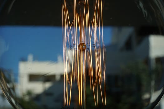 Amazing spiral electric current inside a retro crystal clear light bulb.