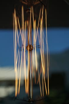 Amazing spiral electric current inside a retro crystal clear light bulb.