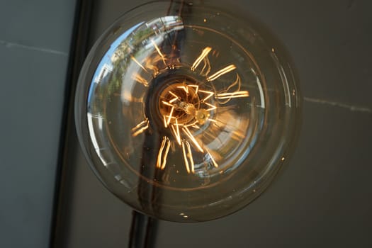 Amazing spiral electric current inside a retro crystal clear light bulb.