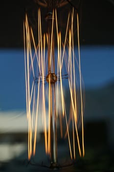 Amazing spiral electric current inside a retro crystal clear light bulb.