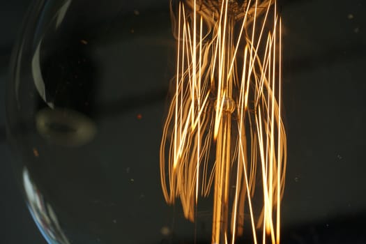 Amazing spiral electric current inside a retro crystal clear light bulb.