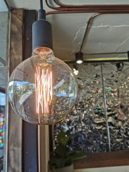 Amazing spiral electric current inside a retro crystal clear light bulb.