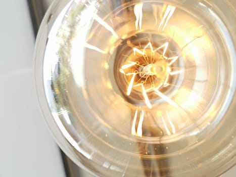 Amazing spiral electric current inside a retro crystal clear light bulb.