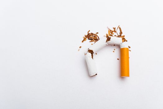 31 May of World No Tobacco Day, no smoking, close up of broken pile cigarette or tobacco STOP symbolic on white background with copy space, and Warning lung health concept