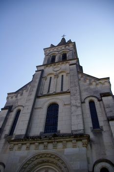 Church spire, looking up to a blue sky in the Indre region, France