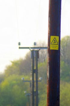 Telegraph pole with a danger warning sign, UK