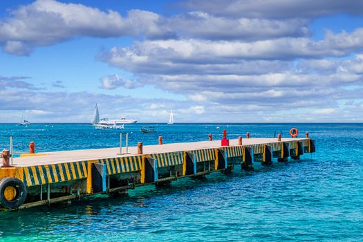 Concrete Pier with Boats in Background in Cozumel