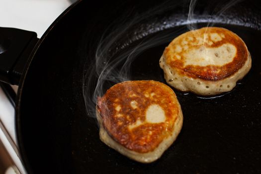 Pancakes fried in a frying pan closeup