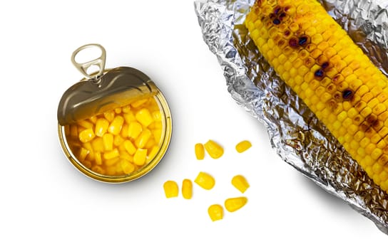 Sweet corn in a tin can and grilled corn in aluminum foil on a white background. Top view.