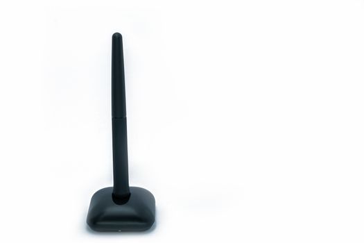Wireless pen mouse on stand for using with computer, side and front on isolated white background.
