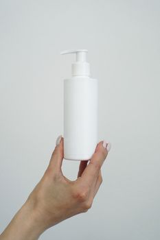 Hand hold blank white tube mock up isolated. Empty cream bottle mockup template holding in hands. Tube design presentation. Skin care mockup