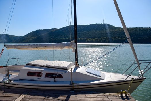 Yacht on the pier near the shore on the lake.