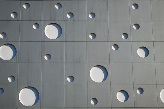 Background texture. A wall with round holes in the form of gas bubbles.