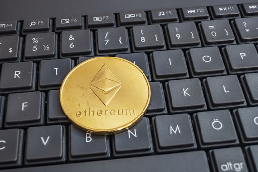 close up cryptocurrency coins on keyboard background