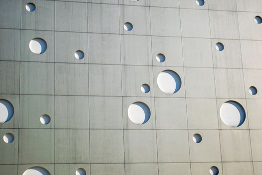 Background texture. A wall with round holes in the form of gas bubbles.