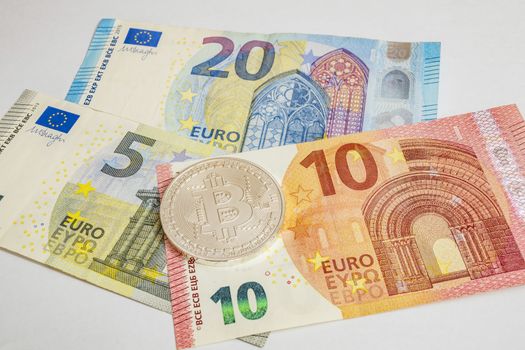 close up cryptocurrency coins on banknotes background