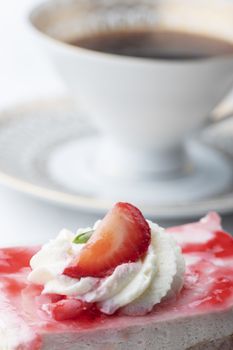 strawberry cake and a cup of coffee